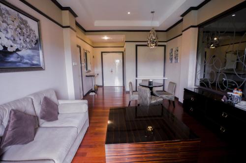 a living room with a couch and a table at Sutanraja Hotel & Convention Centre in Soreang
