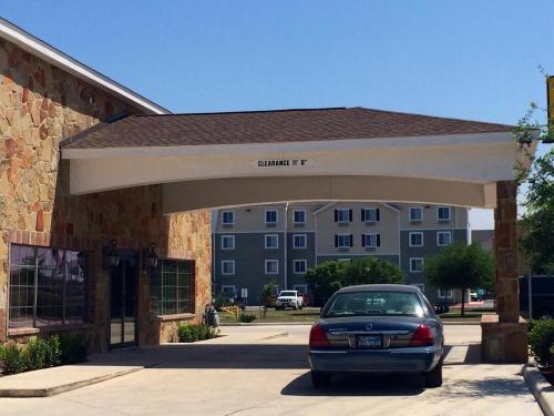 a car parked in front of a building at Super 8 by Wyndham San Antonio Near Fort Sam Houston in San Antonio