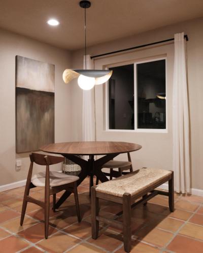 a dining room with a wooden table and chairs at @ Marbella Lane - The Moon Designer Home right behind the JTNP in Joshua Tree