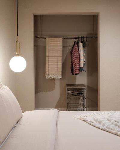 a bedroom with a white bed and a closet at @ Marbella Lane - The Moon Designer Home right behind the JTNP in Joshua Tree