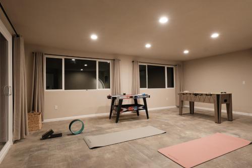 a living room with a ping pong table and mats at @ Marbella Lane - The Moon Designer Home right behind the JTNP in Joshua Tree