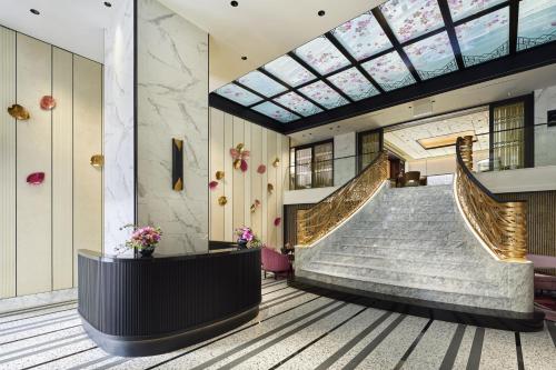 a lobby with stairs and a skylight at Fauchon Hotel Kyoto in Kyoto