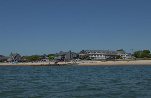 a view of a beach with houses in the background at InnSeason Resorts Captain's Quarters in Falmouth