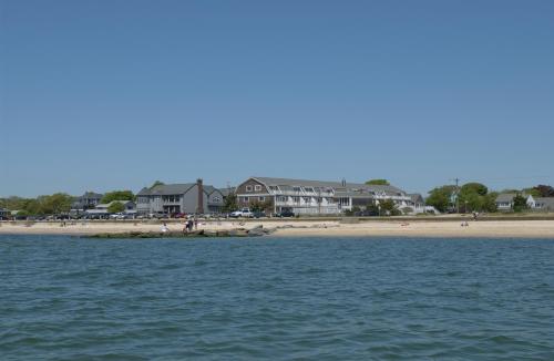 a view of a beach with houses in the background at InnSeason Resorts Captain's Quarters in Falmouth