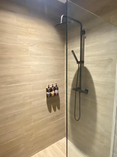 a shower in a bathroom with a glass door at M2 Hotel Waterside in Phayao