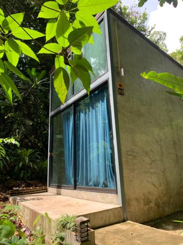 a house with a window with blue curtains at BeachBox@Koh Сhang in Ko Chang