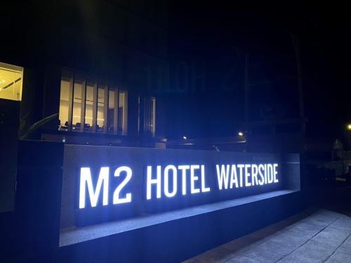 a sign that says hotel warehouse in front of a building at M2 Hotel Waterside in Phayao