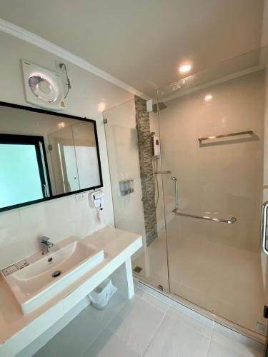 a bathroom with a sink and a shower at ชิดชายชล รีสอร์ท น่าน in Nan