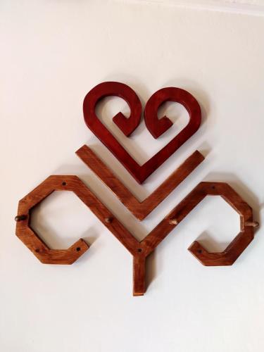 a piece of wood with two hearts on a white wall at Gungas in Ādaži