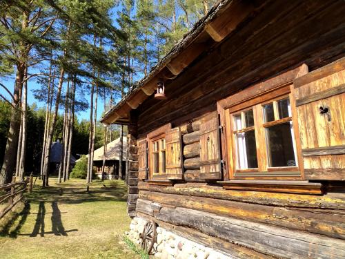 a log cabin with a window on the side of it at Gungas in Ādaži