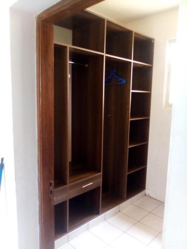 a wooden closet with a glass door at MASKANI Villa in Galu