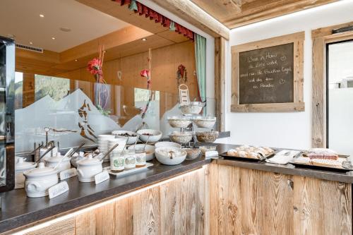 a counter with bowls and other items on display at Hotel Burgstein - alpin & lifestyle in Längenfeld