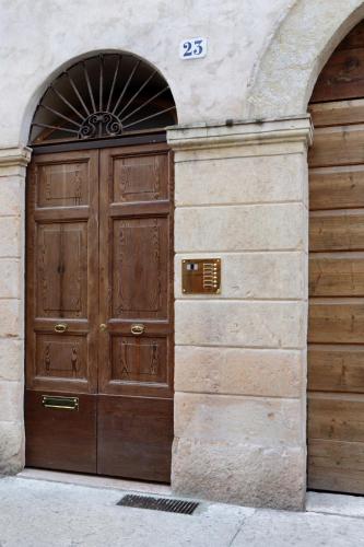 a large wooden door on the side of a building at Residenza Roccamaggiore in Verona