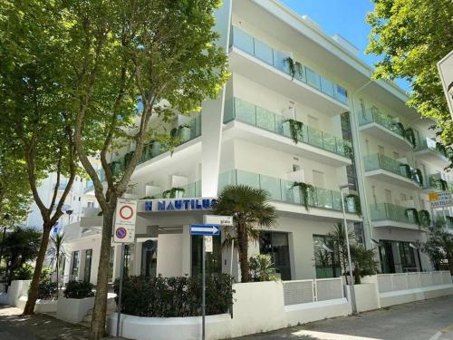 a white building with a sign in front of it at Hotel Nautilus in Bellaria-Igea Marina