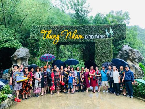 a group of people posing for a picture in front of a zoo at Lotus Hotel Ninh Bình in Ninh Binh