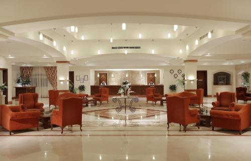 a lobby with chairs and a table in a building at Sharm Grand Plaza Resort - Families and Couples Only in Sharm El Sheikh