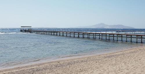 a pier stretches out into the ocean on a beach at Sharm Grand Plaza Resort - Families and Couples Only in Sharm El Sheikh