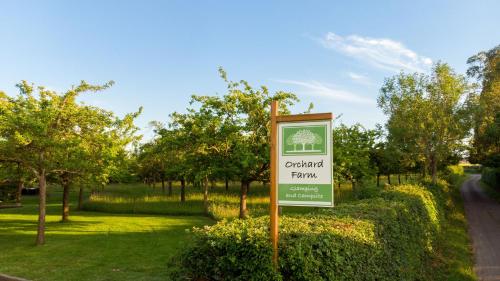 a sign for a park with trees and a road at Orchard Farm Luxury Glamping in Glastonbury