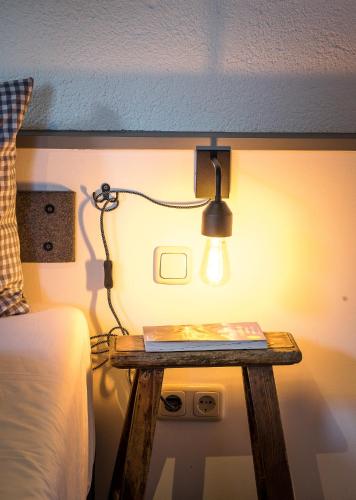 a lamp on a table next to a bed at Das Nordberg Guesthouse in Garmisch-Partenkirchen