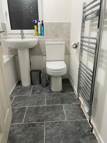 a bathroom with a toilet and a sink at Potters Lodge, Oldham, Manchester by Edl Ventures Ltd in Oldham