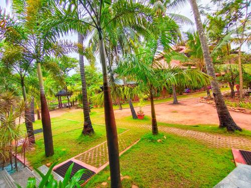 an aerial view of a park with palm trees at Paradise Lagoon in Kalyānpur