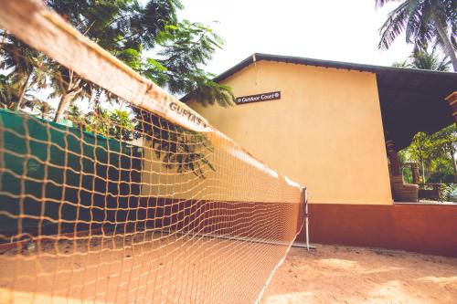 a tennis net in front of a building at Paradise Lagoon in Kalyānpur