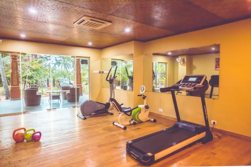 a room with a gym with exercise bikes and a treadmill at Paradise Lagoon in Kalyānpur