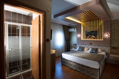 a hotel room with a bed and a window at Şirin Hotel in Istanbul