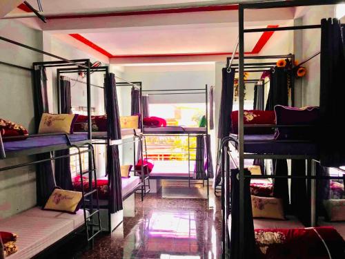 a room with several bunk beds on a bus at Meo Vac Cosy Hostel in Mèo Vạc