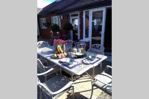 a table and chairs on a patio at Oakville Entire House in Bray
