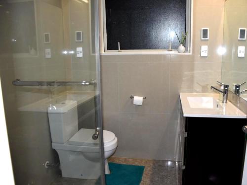 a bathroom with a toilet and a sink at The Rise BNB - Executive Ensuite in Auckland