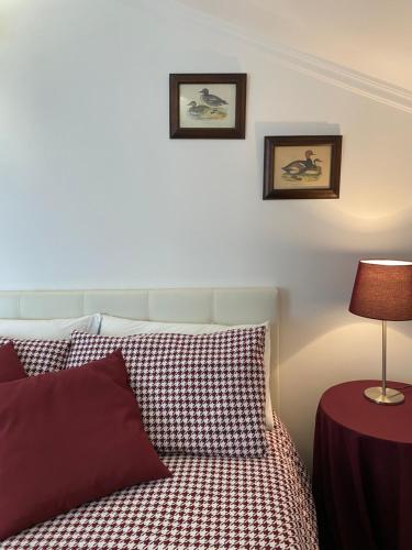 a bedroom with a bed and a table with a lamp at B&B Villa Tersius in Trezzano sul Naviglio