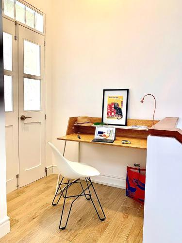 a desk in a room with a white chair at Casa Rambla Serra Cali in Cali
