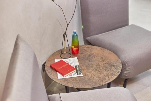 a table with a book and a bottle on it at Stixiya in Odesa