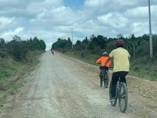 two people riding bikes on a dirt road at Mirador Bosque Gran Torino Neusa in Cogua