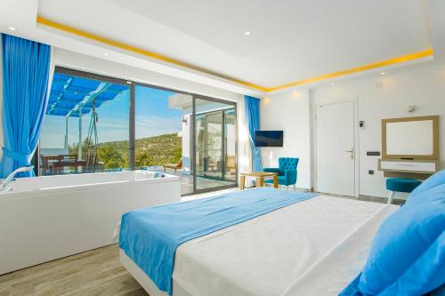 a bedroom with a king sized bed and a bathtub at VillA Esin in Kaş