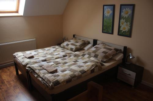 a bedroom with a bed with a quilt on it at Hotelik Za Murem in Kołobrzeg