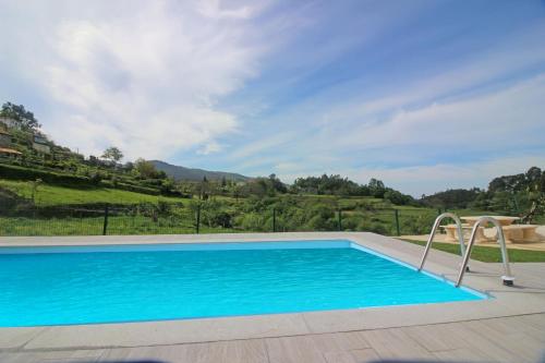 a swimming pool with a view of a mountain at Casa das Laranjeiras by Gerês Casas in Carvalheira