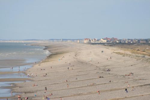 a group of people on a beach near the water at studio9 in Ault