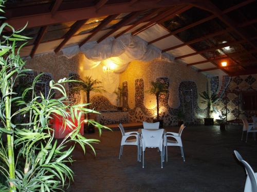 a room with a table and chairs and plants at Posada del Indiano in Cidones