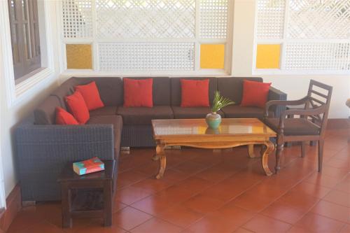 a living room with a couch and a coffee table at Lanka Beach Boutique Bungalows & Grand Villa in Tangalle
