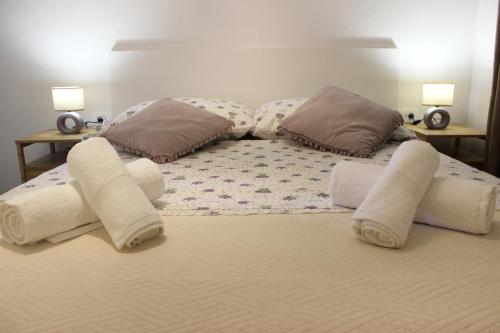 a bed with white towels and pillows on it at THE VIEW in Pučišća