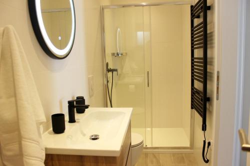 a white bathroom with a sink and a shower at THE VIEW in Pučišća