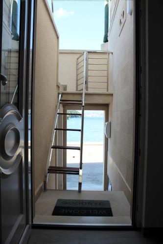 a stairway leading to a room with a view of the ocean at THE VIEW in Pučišća
