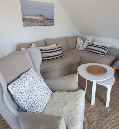 a living room with a couch and a table at FeWo Machedanz am Hafen Timmendorfer Strand OT Niendorf in Timmendorfer Strand