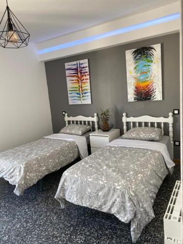 sypialnia z 2 łóżkami i obrazem na ścianie w obiekcie SALOU : SPACIEUX APPARTEMENT 100 M2 vue sur mer w Salou