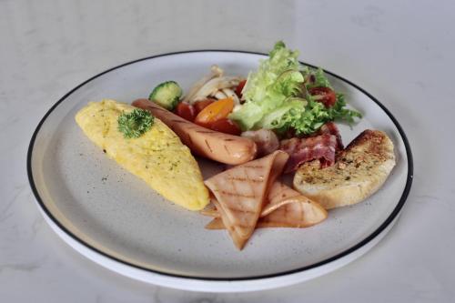 a plate of food with meat and vegetables on it at M2 Hotel Waterside in Phayao