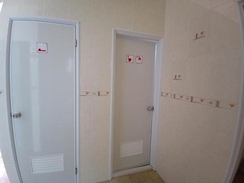 a bathroom with two shower stalls next to a door at 隱君子的撒野 