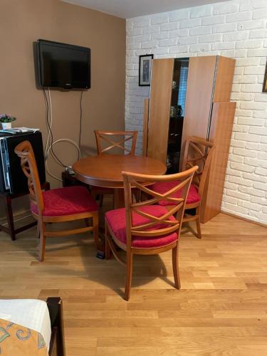 a dining room with a table and chairs and a tv at Villa Astoria in Balatongyörök