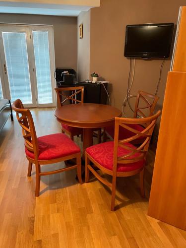 a room with a table and two chairs and a television at Villa Astoria in Balatongyörök